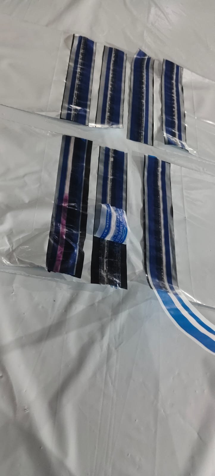 Applied security seals on white bags, one of which shows the heat indicator stripe turned pink
