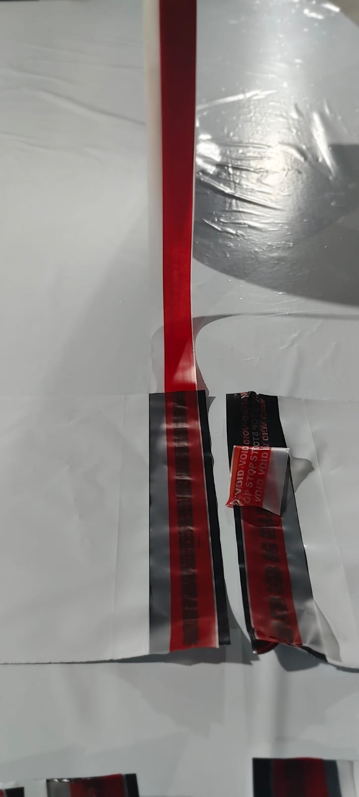 A lifted seal showing a repeating red VOID STOP message transferred onto the packaging